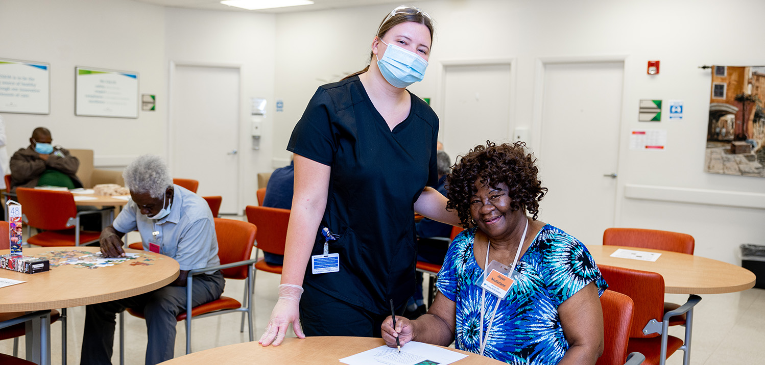 Activities director with participant in day center