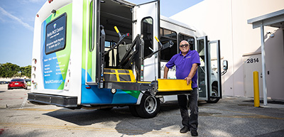 Bus driver posing with elevated chair lift